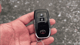 a hand is holding a toyota car key