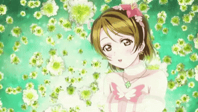 a girl in a pink dress and necklace is surrounded by flowers .