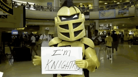 a yellow mascot holding a sign that says i 'm knights