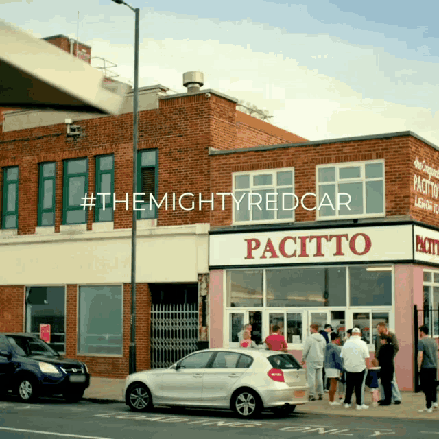 a white car is parked in front of a building that says pacifico