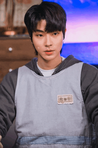 a close up of a person wearing a hoodie with a patch that says ' flowers ' on it
