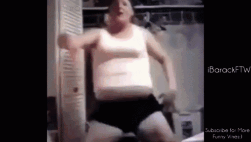 a fat man in a white tank top and black shorts is dancing in a room .