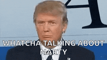 donald trump is wearing a suit and tie and making a funny face while talking about marty .