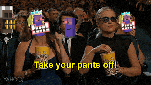 two women are watching a movie and one of them is holding a cup of popcorn