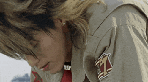 a close up of a person wearing a jacket with a patch on the sleeve that says tz