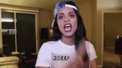 a woman wearing a hat and a white t-shirt says deep