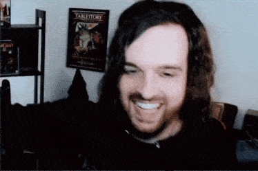 a man is smiling in front of a table story poster