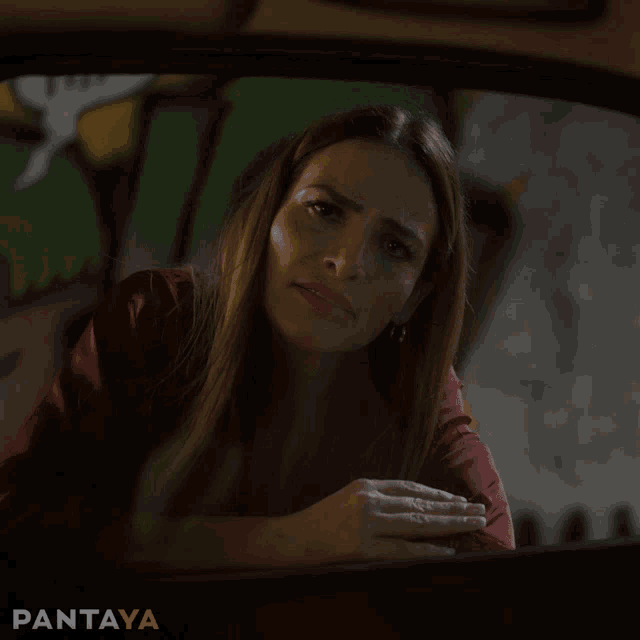 a woman blowing a kiss in a car with the word pantaya behind her