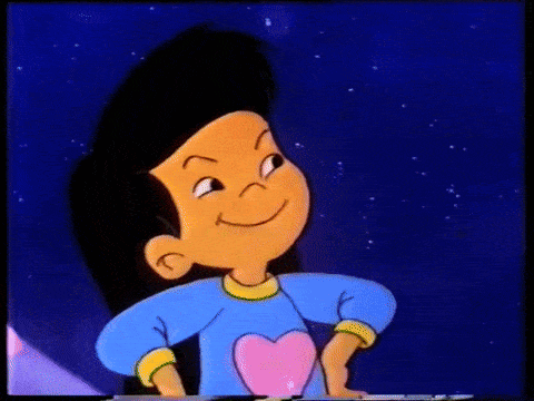 a cartoon character is pointing up with his finger while wearing a blue shirt with a heart on it .