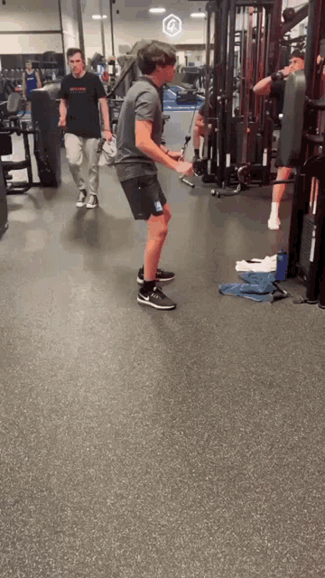 a man in a gym wearing a t-shirt that says nike on it