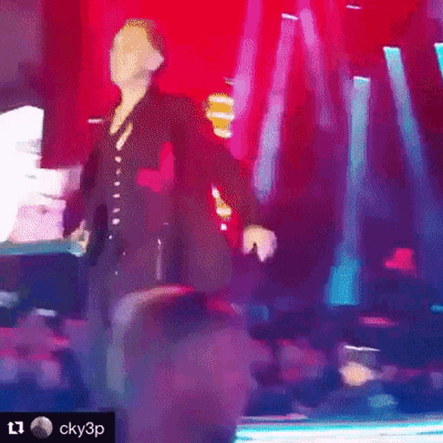 a man is dancing on a stage in front of a crowd with the hashtag cky3p on the bottom