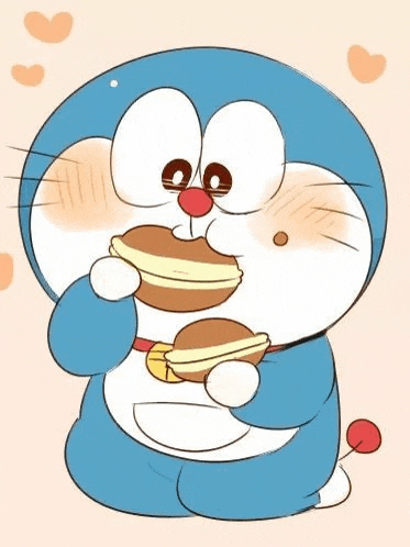 a doraemon cartoon character is eating a pancake .