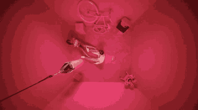 a man laying on the floor in a pink room