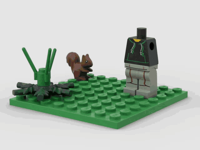 a lego figure is holding a pretzel next to a squirrel and a flower