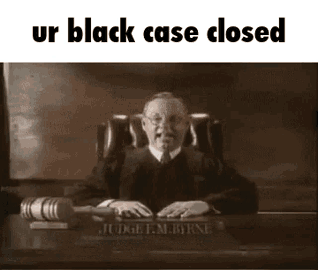 a black and white photo of a judge sitting at a desk with a judge 's gavel .