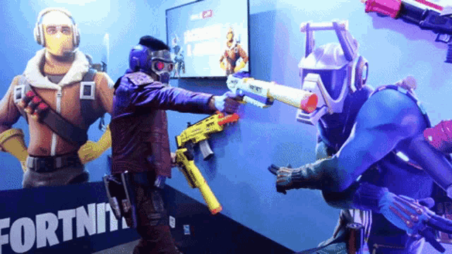 a man holding a nerf gun in front of a fortnite sign