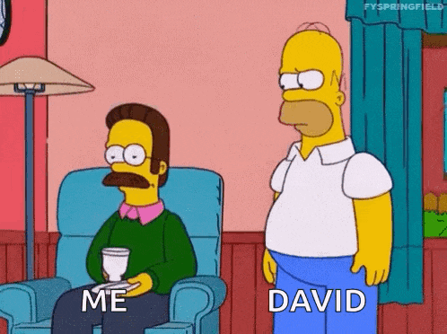 a cartoon of homer simpson sitting in a chair next to a man with a mustache .