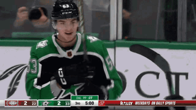 a hockey player in a green jersey with the number 33 on the front