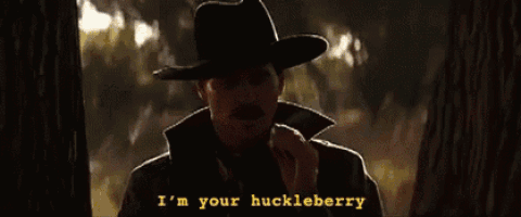 a man in a cowboy hat is saying " i 'm your huckleberry "