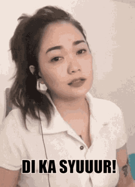 a woman wearing ear buds and a white shirt says di ka syuur