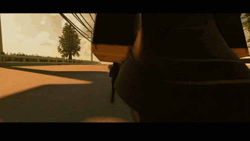 a person walking down a road with a yellow object on their back