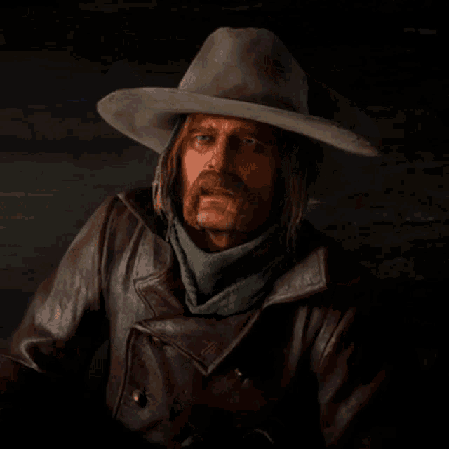a man wearing a cowboy hat and a scarf