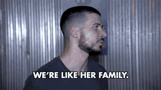 a man says " we 're like her family " in front of a metal wall