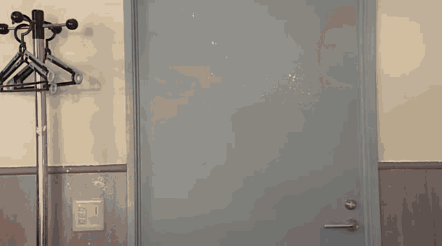an empty room with a door and a light switch