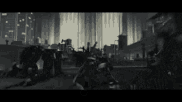 a black and white image of a group of people standing in a room .