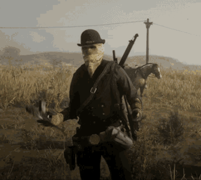 a man with a mask on his face is standing in a field with a horse in the background