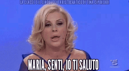 a woman in a blue dress is saying maria senti io ti saluto ..