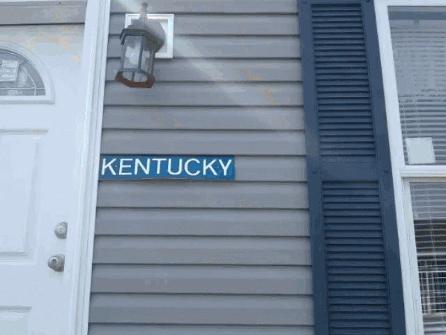 a blue kentucky sign on the side of a building