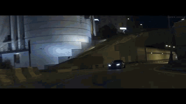 a car is driving down a curvy road at night