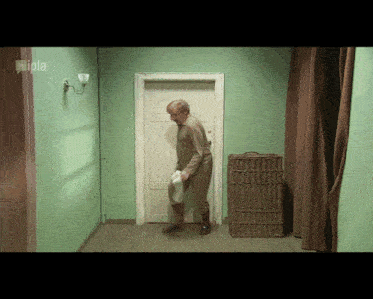 a man is standing in a hallway with a sign on the wall that says filipa