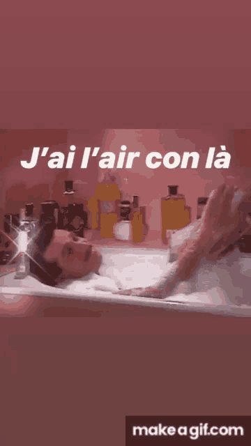 a man is laying in a bathtub with the words j'ai l' air con la