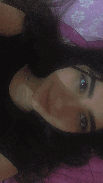 a close up of a woman 's face with a pink background