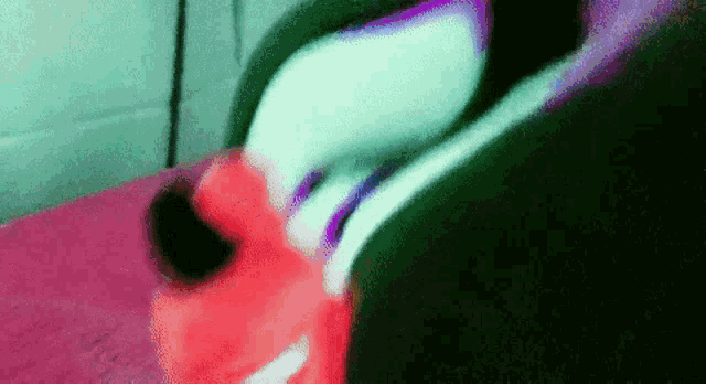 a blurred image of a person 's feet with a red shoe in the foreground