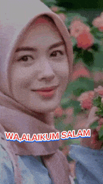 a woman wearing a pink hijab is holding flowers and the words wa alaikum salam are above her