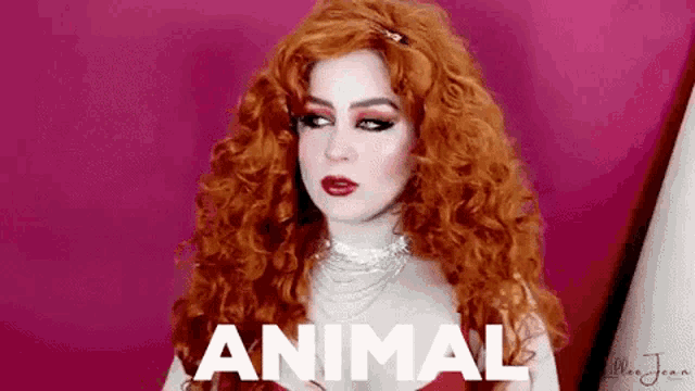 a woman with red hair is wearing a red dress and a necklace and the word animal is on her face