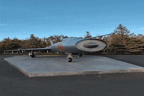 a gray airplane with the number 57 on the side