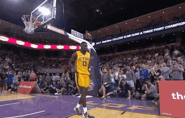 a basketball player in a yellow jersey with the number 13 on it