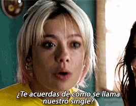 a woman in a yellow shirt is talking to another woman .