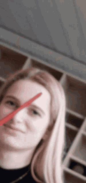 a woman 's face is shown with a red arrow pointing to her eye