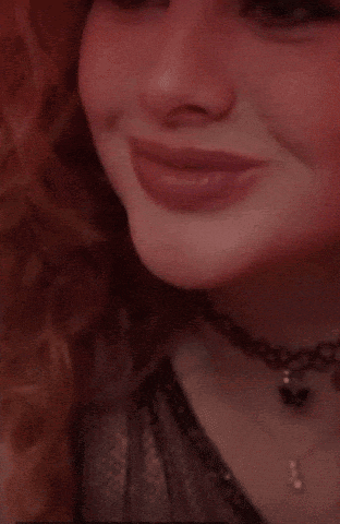 a close up of a woman 's face making a funny face with her eyes closed .