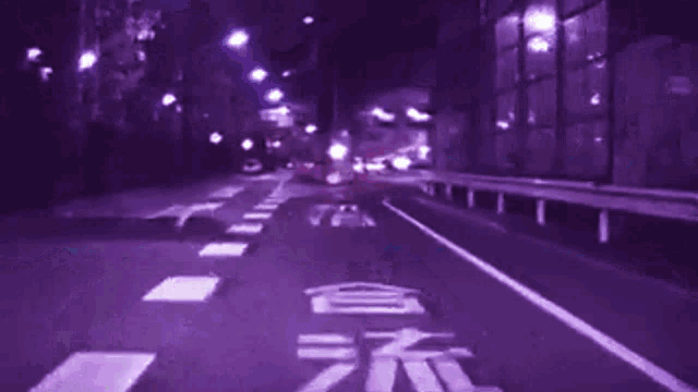 a blurry picture of a street with a purple background and the number 19 on the road