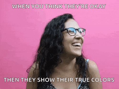 a woman wearing glasses is smiling with the caption when you think they 're okay then they show their true colors below her