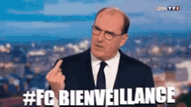 a man in a suit and tie giving the middle finger