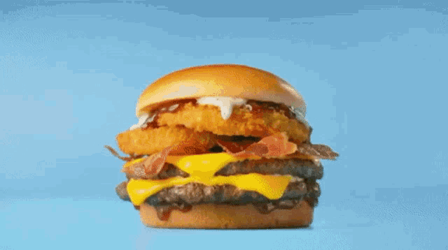 a close up of a hamburger on a blue surface