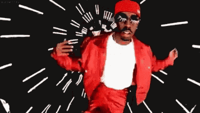 a man in a red jacket and hat is dancing with his arms outstretched on a black background .