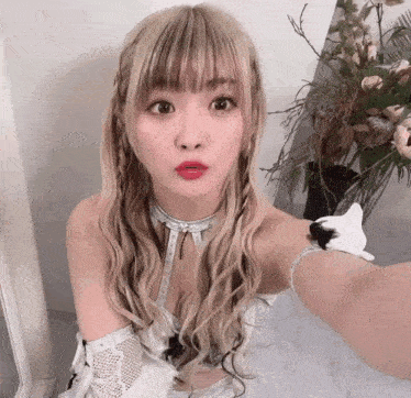 a woman with blonde hair is taking a selfie